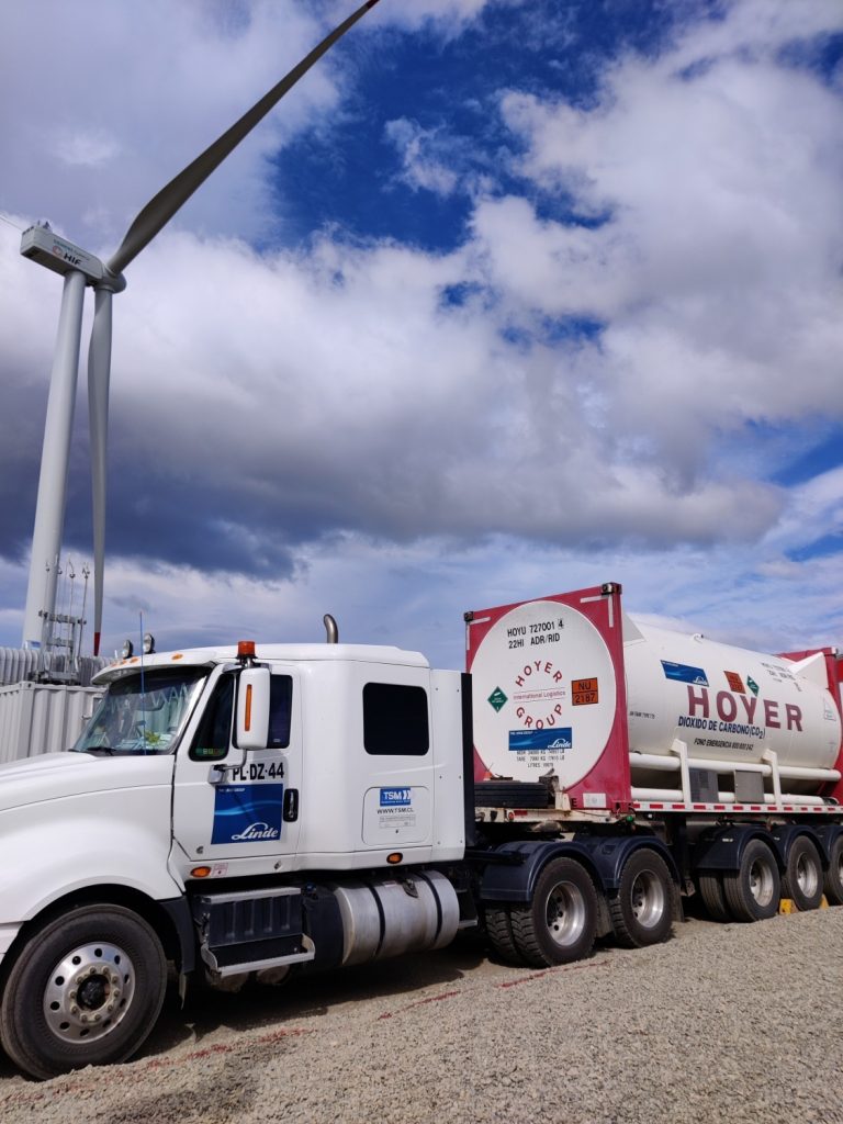 Truck in front of a wind turbine