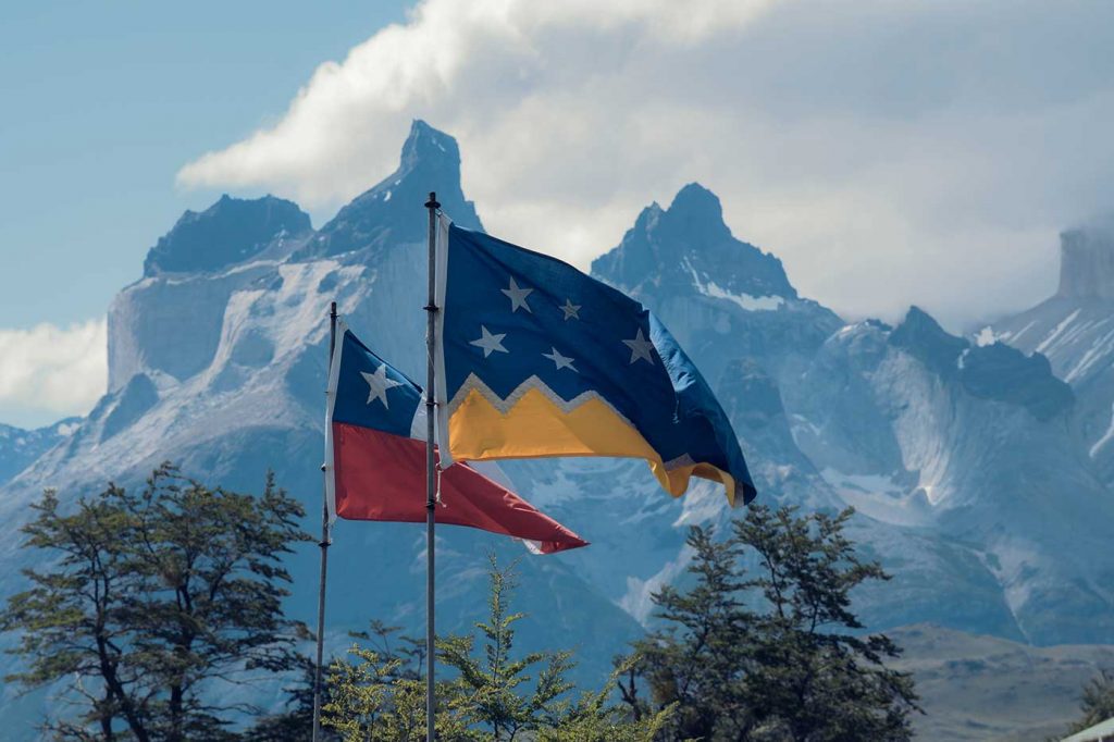 Flags of Magallanes and Chile in front of mountain